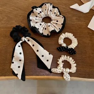 Elegant set of four chic polka dot bow scrunchies with pearls and ribbons for women