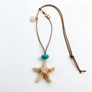 Beach vacation necklace with a realistic starfish pendant and small shell charms