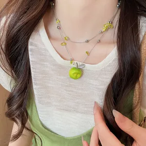 Detailed close-up of Mori style necklace featuring green apple pendant and clear beads