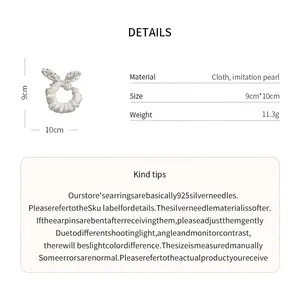 Detail view of cloth lace hair scrunchie with polka dot bow and pearl decoration