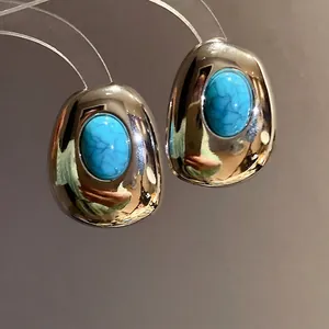 Elegant vintage oval resin stud earrings with turquoise stone and high-shine metallic finish.