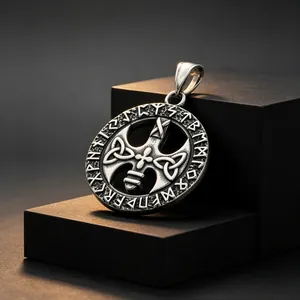 Detail of vintage titanium steel Viking pendant with Runic and Celtic engravings.