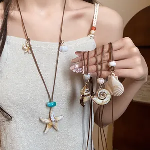 Detailed view of resort style starfish and shell pendants on brown cord necklaces for women
