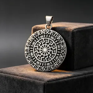 Macro shot of a stainless steel Viking rune pendant with an intricate sun wheel engraving.