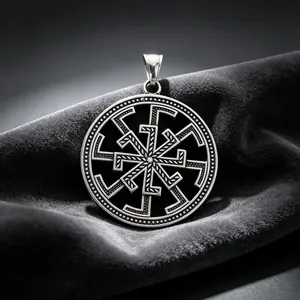 Macro shot of a Slavic Kolovrat solar symbol pendant on dark velvet fabric.