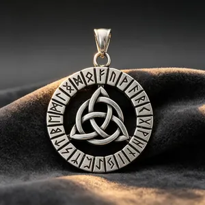 Close-up of vintage titanium steel Viking pendant with Celtic knot and Elder Futhark runes