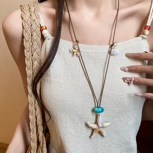 Detail showing the intricate starfish and shell charms on this vacation style necklace