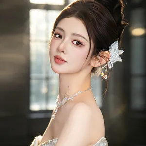 Detailed shot of ethereal lace butterfly crystal ear cuff and necklace on an Asian model
