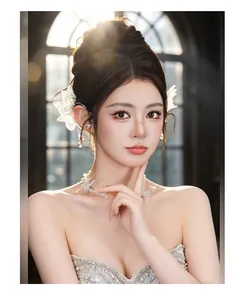 Detailed view of lace butterfly crystal pendant ear wrap worn by an elegant female model