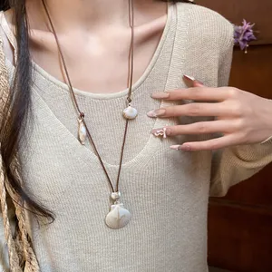 Detailed close-up view of an original resort style shell necklace for beach vacations.