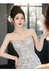 Detail shot of butterfly crystal ear cuffs and necklace worn by an elegant bride.
