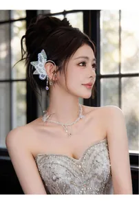 Detailed view of an elegant lace butterfly ear cuff with shimmering crystal pendants