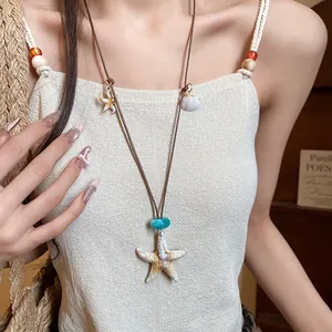 Model wearing a brown cord necklace with starfish and seashell charms for beach style