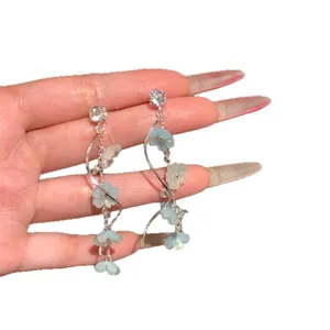 Elegant long tassel drop earrings featuring light blue flowers and sparkling crystals