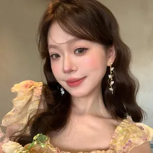 Close-up of elegant long tassel floral earrings worn by a model in a fairy style
