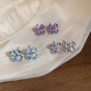 Detailed macro view of four-leaf clover stud earrings with colorful cubic zirconia