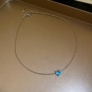 Minimalist French style necklace with a blue heart pendant and silver cord chain