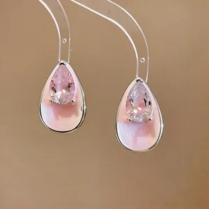 Detailed view of elegant pink teardrop earrings with sparkling zircon and enamel finish.