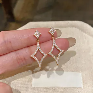 Close-up detail of 18k gold plated star earrings with brilliant micro-pave zircons