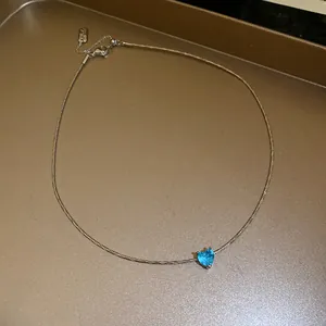 Elegant minimalist French style necklace with a small blue heart-shaped crystal pendant.