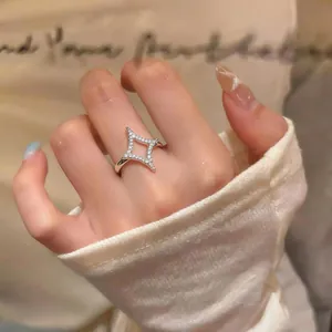 Close-up of a 18k gold plated star ring with sparkling cubic zirconia on a models hand