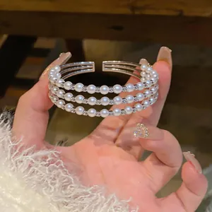Dettaglio del bracciale a tre strati di perle in stile vintage con strass