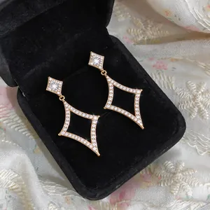 Elegant 18k gold-plated star earrings with zirconia displayed in a black velvet box
