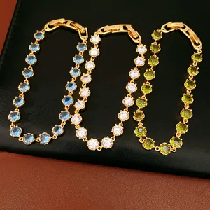 Close-up of 18k gold plated bracelets featuring colorful round-cut zircon stones