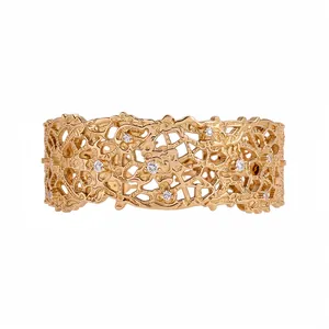 Gold open cuff bracelet featuring elegant French lace textures and crystal stone accents