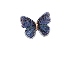 Vintage knitted blue butterfly hair clip with elegant gradient texture and golden metal core