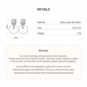Detail view of French style round resin earrings with rhinestone studs and size info