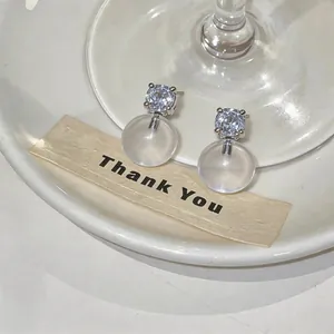 Macro detail of elegant French style resin ball stud earrings with sparkling rhinestones