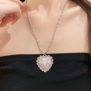 Close-up of pink heart cat-eye stone necklace with vintage palace style on a model