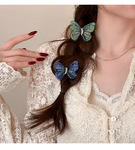 Detail shot of vintage knitted butterfly hair clips worn on a braided hairstyle.