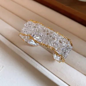 Detail view of the intricate lace texture and sparkling diamonds on this cuff bracelet