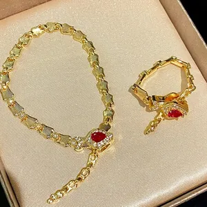 Exquisite luxury snake-shaped gold jewelry set with pigeon blood red stones and crystals