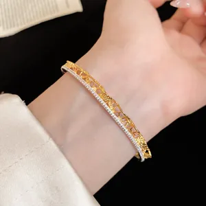 Detailed view of elegant gold lace texture open bangle with sparkling diamond lining