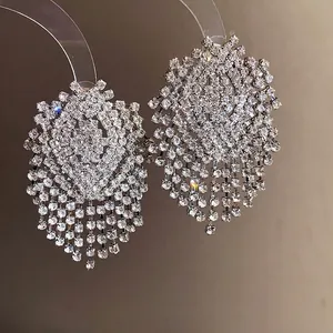 Sparkling silver geometric tassel earrings with dense rhinestone embellishments.