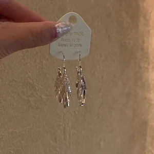 Detailed view of silver sequin tassel earrings featuring multi-layered fringe design