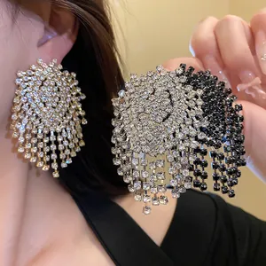Close-up detail of elegant silver needle geometric tassel earrings with rhinestones