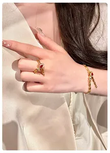 Vintage style gold bracelet and adjustable ring set with pear-shaped red gemstone