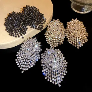Close-up of geometric rhinestone tassel earrings showing silver, gold and black options