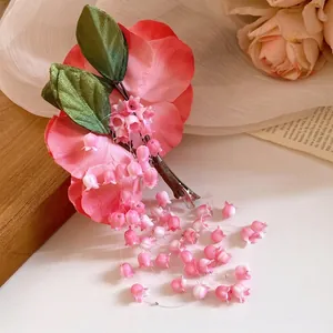 Elegant pink fabric flower hair clip featuring dangling bell orchid tassels and silk leaves