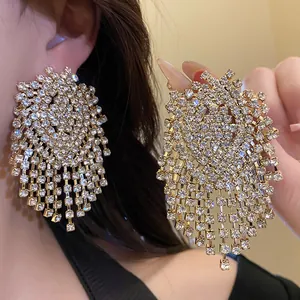 Close-up of sparkling rhinestone geometric tassel earrings with silver needle posts