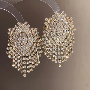 Close-up detail of luxury geometric tassel earrings with sparkling rhinestones set