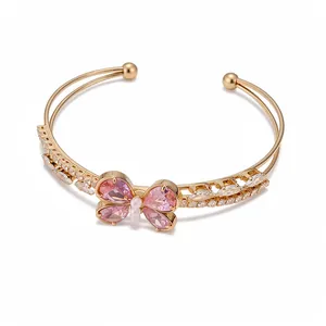 Elegant double-layer open bangle with a pink zircon butterfly and sparkling stones.