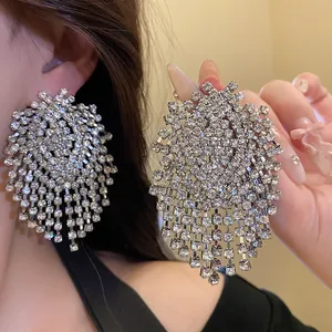 Exquisite oversized rhinestone tassel earrings with geometric design, sparkling detail view