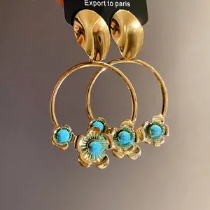 Hochwertige goldene Creolen mit türkisfarbenen Blumenanhängern aus Acryl und Metallsteckern