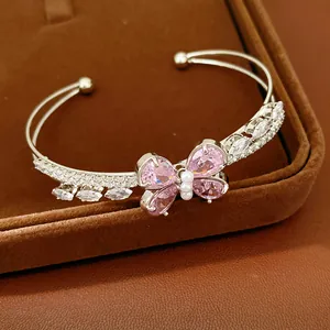 Detailed macro view of the pink zircon butterfly on a silver double-layered cuff bracelet