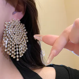 Close-up of sparkling geometric tassel earrings with rhinestone silver needle design